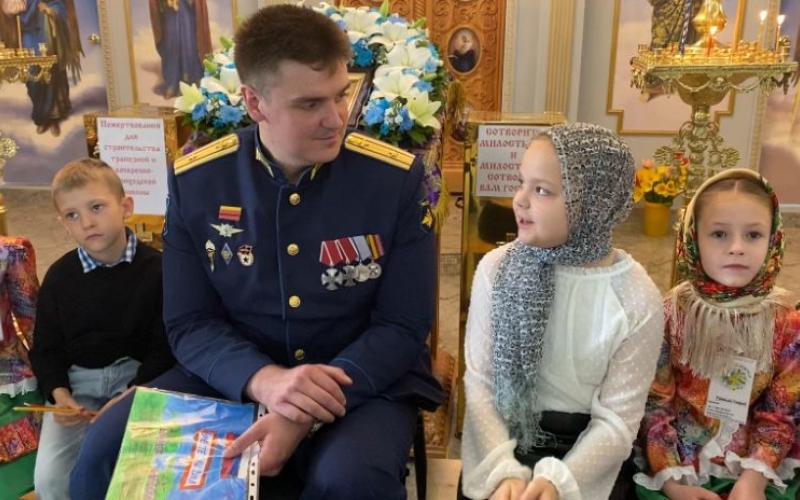 Дети в храме общаются с героем СВО.